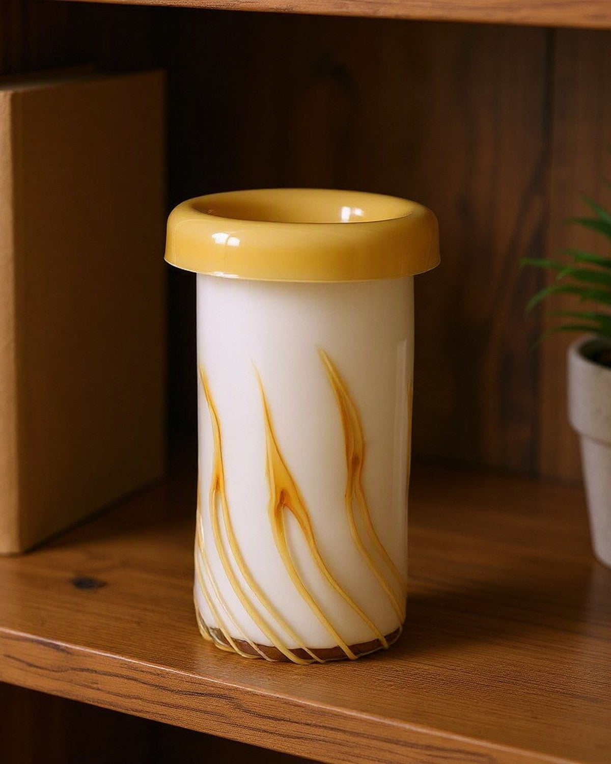 Curled Mouth Yellow-Striped Vase on a shelf