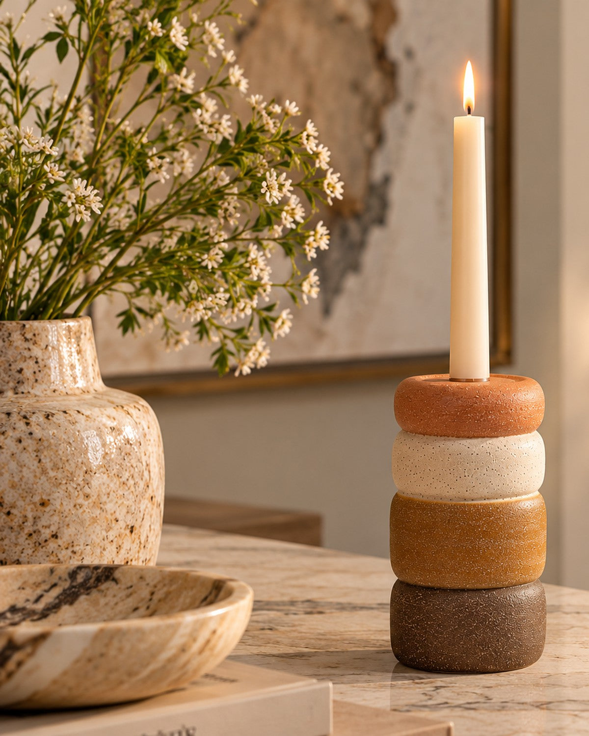 earth tones holds a white candle
