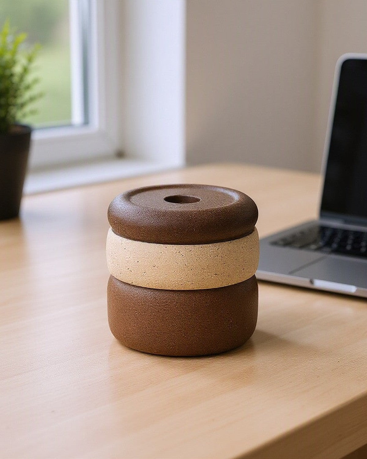 Multicolor Round Ceramic Candlestick on a desk